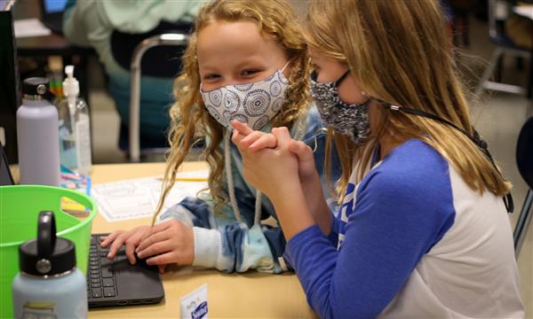 Girls work on Escape Room problems